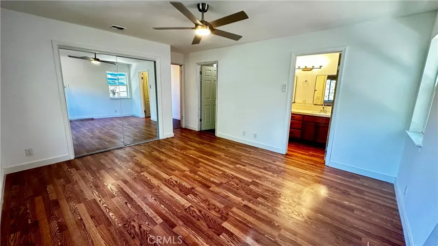 Master Bedroom, Mirrored Wardrobes, Laminate Floors.