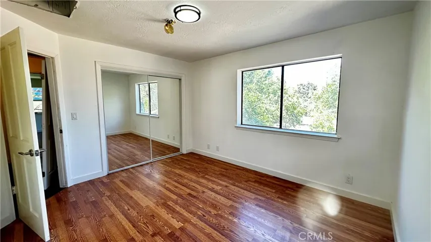 Large second bedroom with new laminate floors and mirrored wardrobes.  New Light.