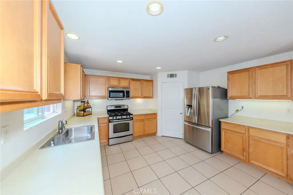 A lot of counter space and cabinet storage. Door next to fridge leads to step-in pantry.