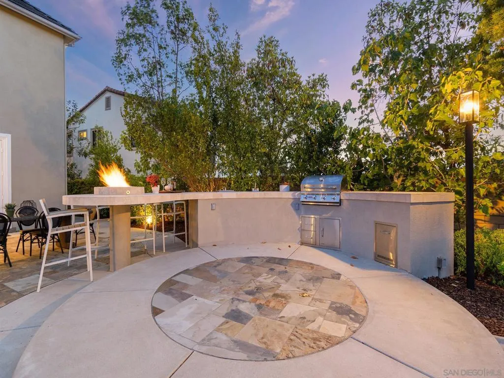 Gorgeous bbq bar with sink , beverage center new bull Bull BBQ and counter top firepit.