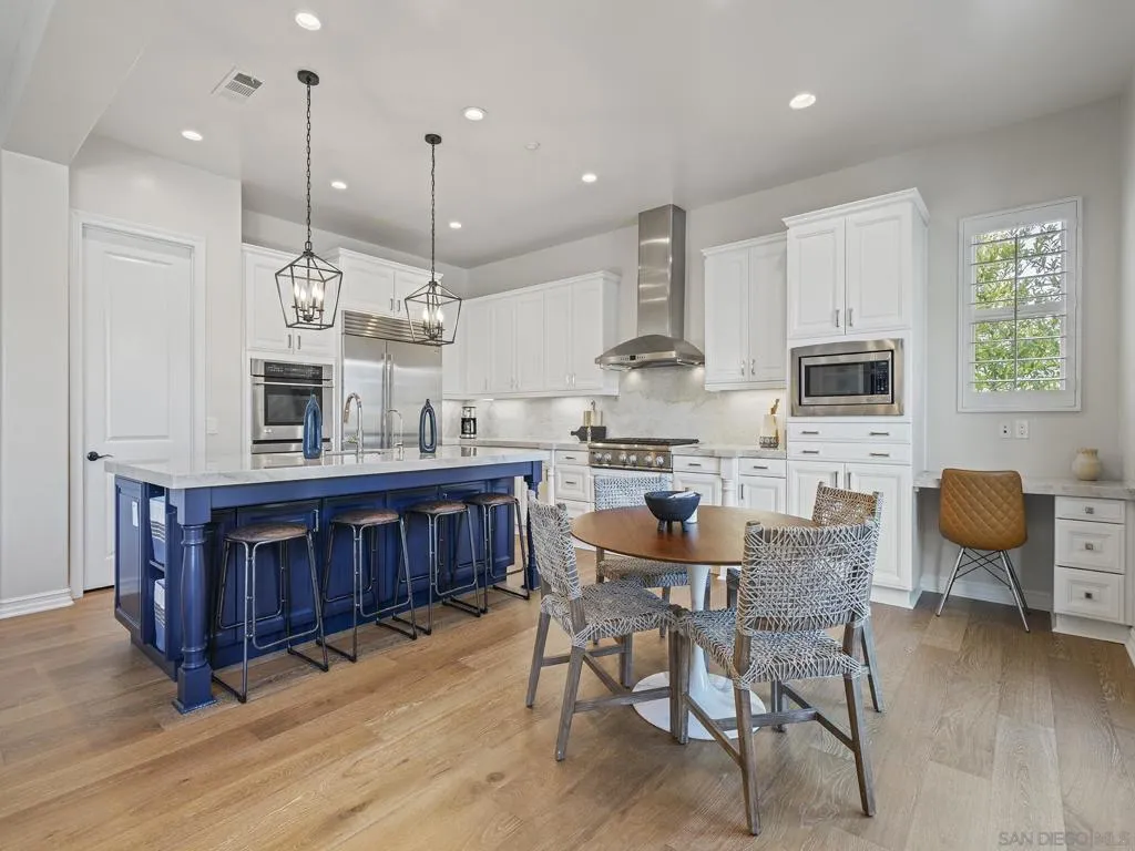 Remodeled chef's kitchen with taj mahal quartzite counters, beautiful hardware and fixtures, and top of the line appliances and lighting.