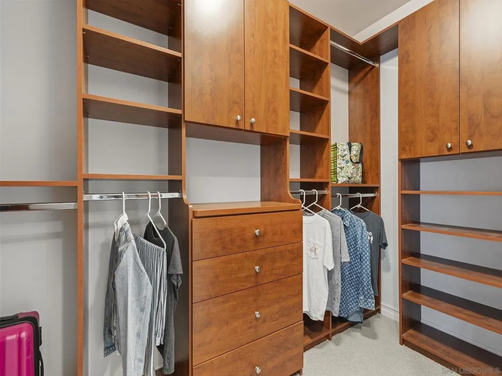 His and her walk in closets with custom built ins.