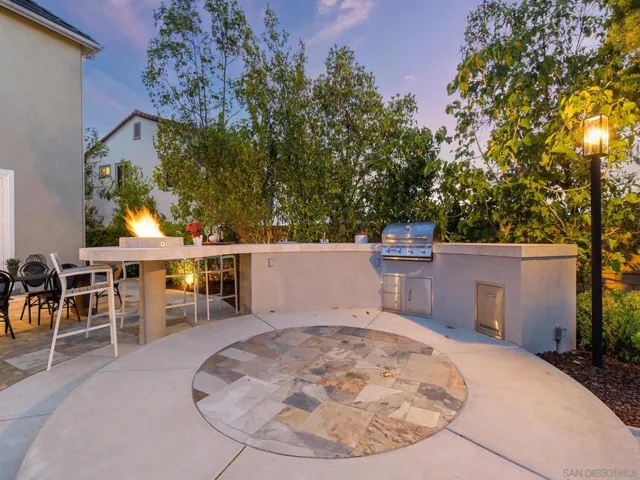 Gorgeous bbq bar with sink , beverage center new bull Bull BBQ and counter top firepit.