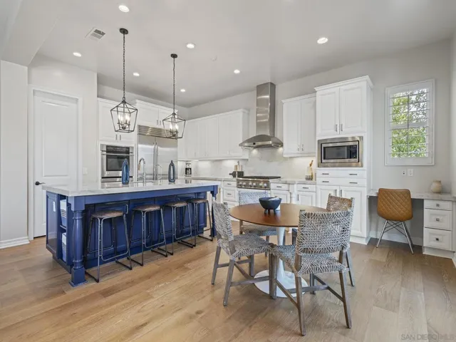 Remodeled chef's kitchen with taj mahal quartzite counters, beautiful hardware and fixtures, and top of the line appliances and lighting.