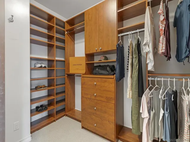 His and her walk in closets with custom built ins.