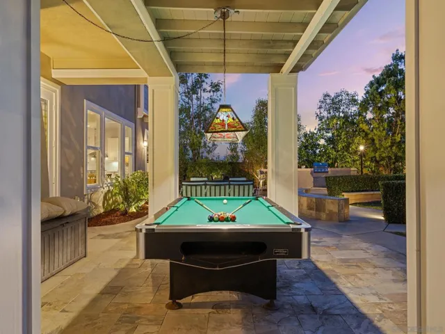 Great covered patio under primary balcony , great for games or another dining room outside.