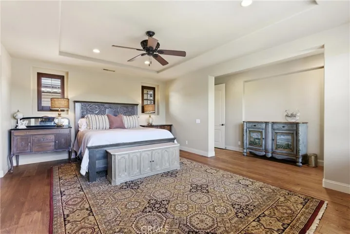 Alternate view of the primary suite showcasing the generous proportions and flexible sitting area potential.