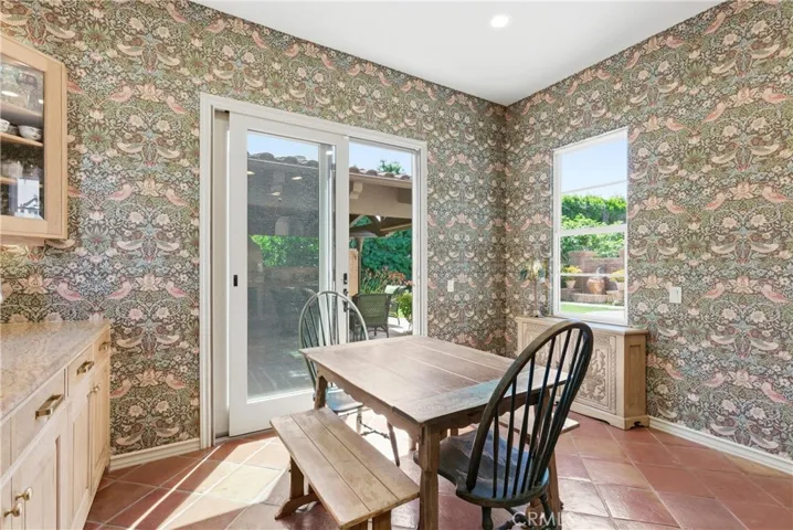 Bathed in natural light, the breakfast nook provides a cozy setting for casual dining while overlooking the beautifully landscaped backyard.