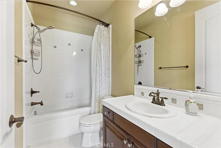 bathroom with Tub/shower combination and ample vanity space.