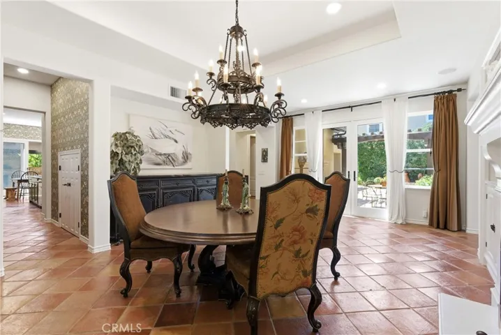 French doors open to outdoor living areas, creating an effortless indoor-outdoor connection ideal for gatherings and special occasions.
