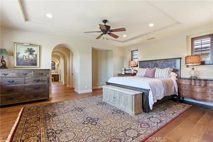 Expansive primary suite featuring a tray ceiling, oversized layout, and private retreat-like ambiance.