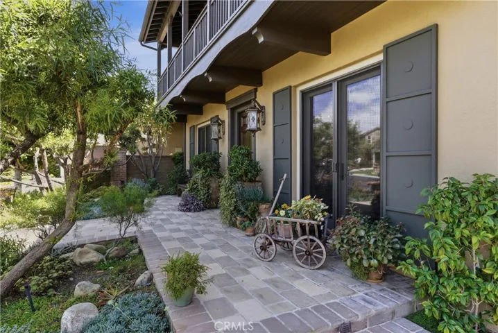 The expansive covered porch provides a peaceful setting to relax and enjoy the surrounding gardens while embracing the home's indoor-outdoor lifestyle.