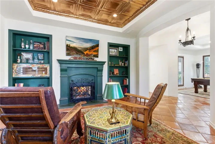 Warm and inviting, the library offers custom built-ins, architectural detailing, and a cozy fireplace creating the perfect retreat.