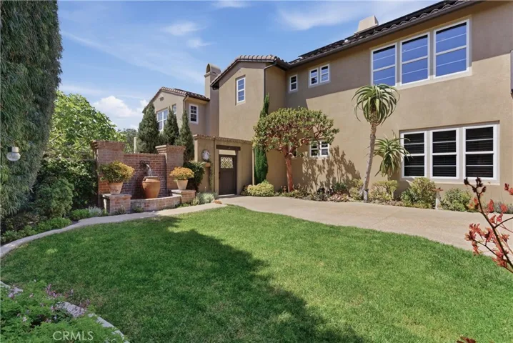 Private backyard retreat with manicured lawn, mature landscaping, and direct access to the outdoor entertaining pavilion.