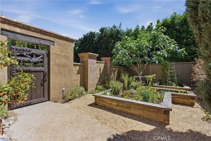 Raised garden beds create a charming space for growing herbs, vegetables, and seasonal flowers.
