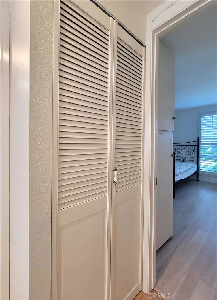 Hallway closet housing stack laundry.