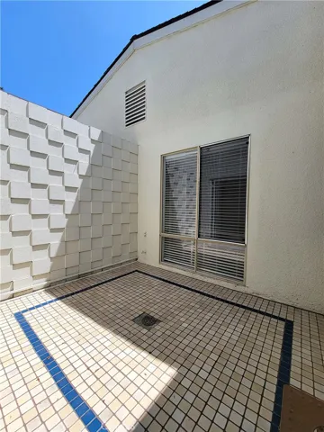 Open to the sky with tiled floor.