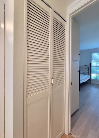Hallway closet housing stack laundry.
