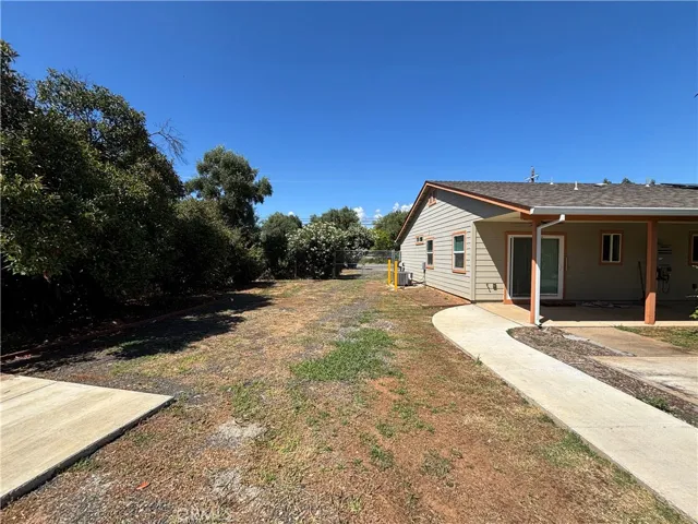 View of side of home and access to your spacious back yard and shop