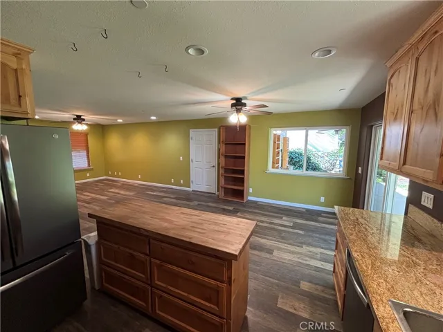 Kitchen with view of moveable island and dining room off living room