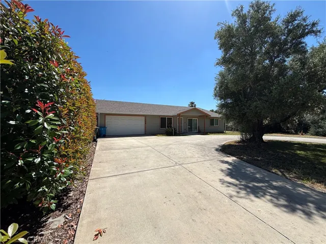 Circular drive with mature landscaping welcomes you home
