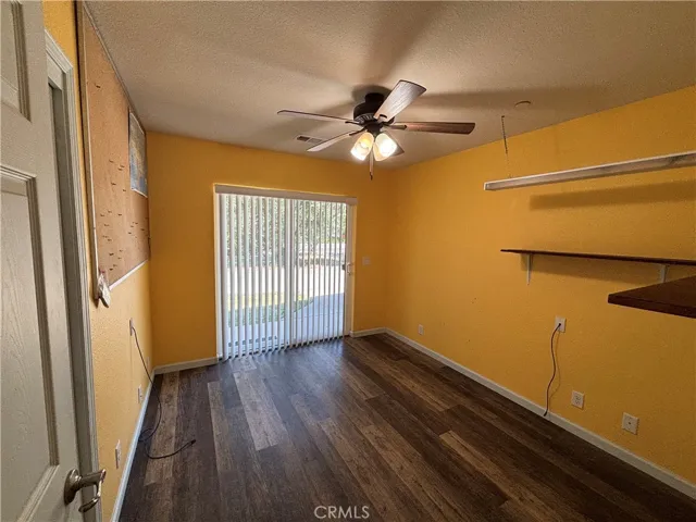 Office or third bedroom with ceiling fan and slider to front yard