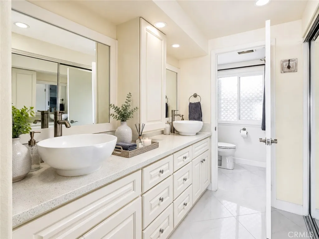 Primary bathroom. Digitally enhanced with virtually staged furniture