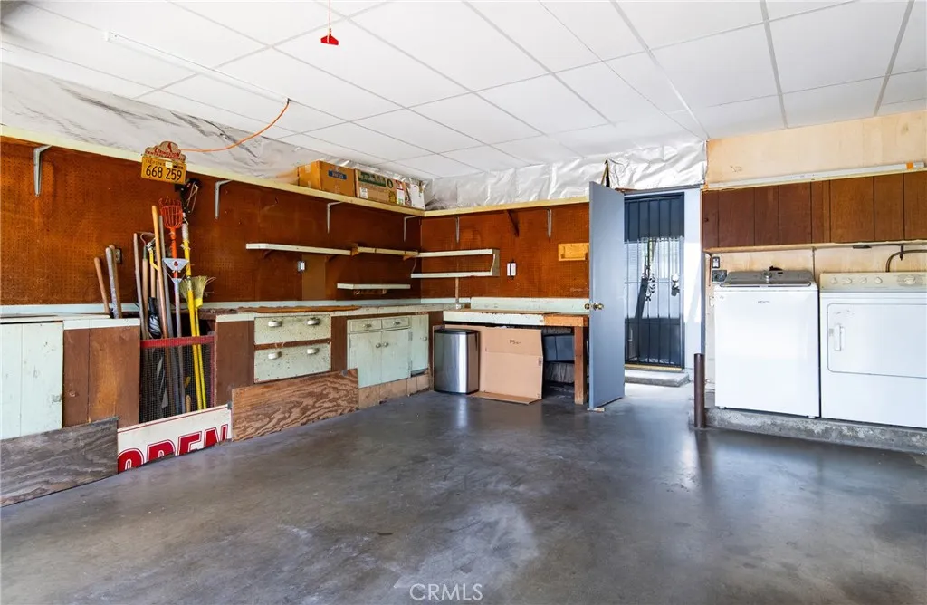 Large garage with washer and dryer and lots of cabinetry.