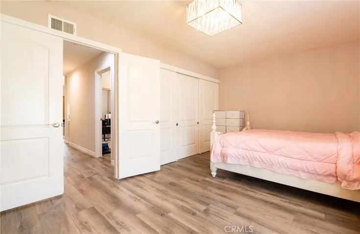 Double-door Master Bedroom Suite.  Large room with 1/4 bathroom vanity and standing shower.