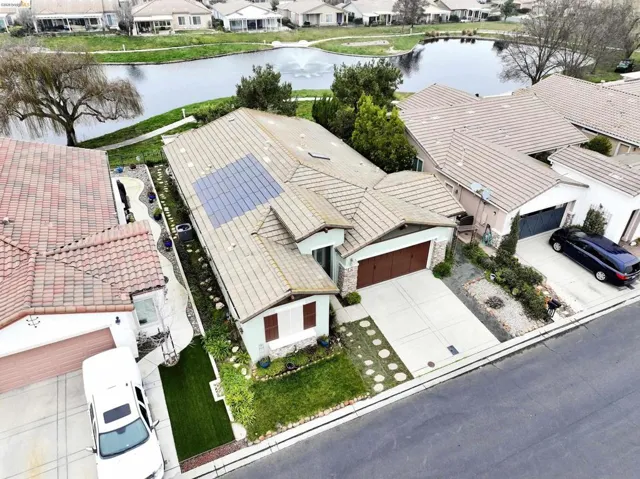 Aerial perspective of suburban area featuring a large body of water