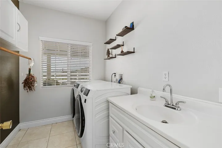 Indoor laundry room with utility sink.