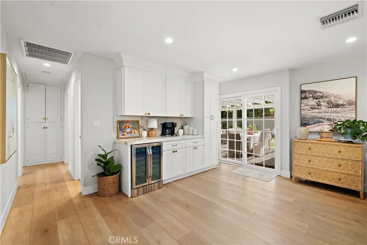 The family room has a quartz buffet counter with wine fridge and cabinetry