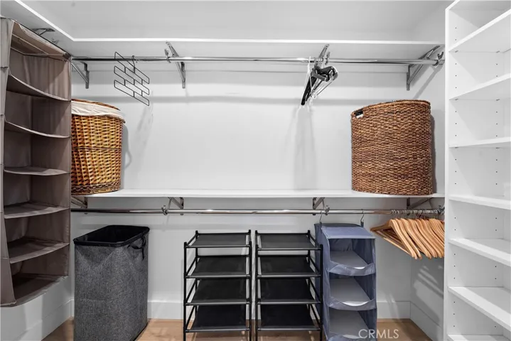 Large walk-in closet in primary suite with shelving