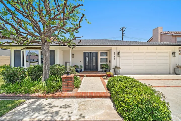 Gorgeous curb appeal with brick accented walkway and driveway, welcoming brick covered porch, and double door entry. Plus newer roof (2022)