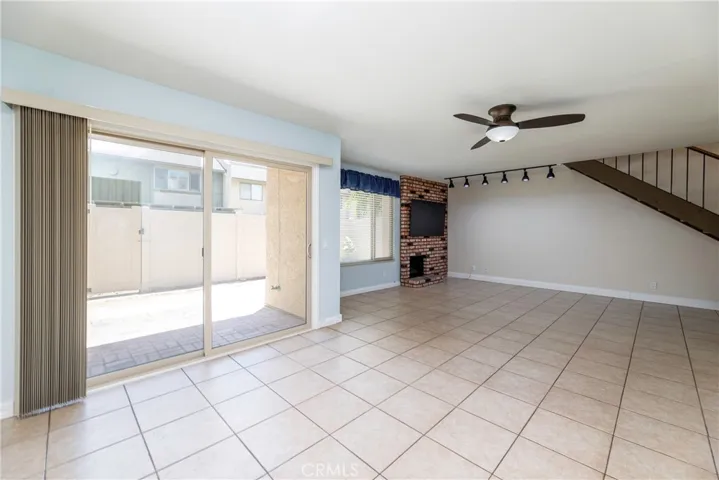 Bright Living room with slider to the patio and ceiling fan