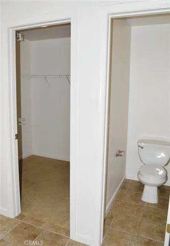 Side by side master walk in closet and water closet for toilet
