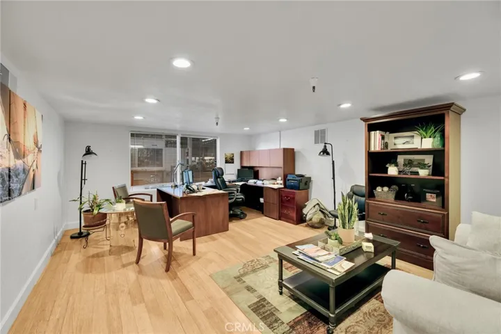 3rd office featuring an interior viewing window to warehouse work area