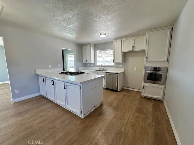 Kitchen – Well-appointed kitchen featuring extensive counter space, a center island, built-in oven, and clean, contemporary finishes designed for everyday convenience.