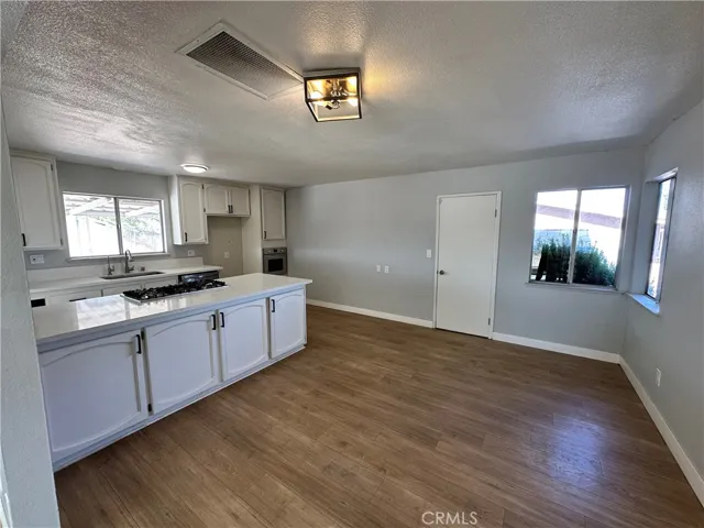 Kitchen & Dining Area – Open kitchen and dining space with abundant natural light, generous floor area, and a central island that creates a functional gathering and meal-prep hub.
