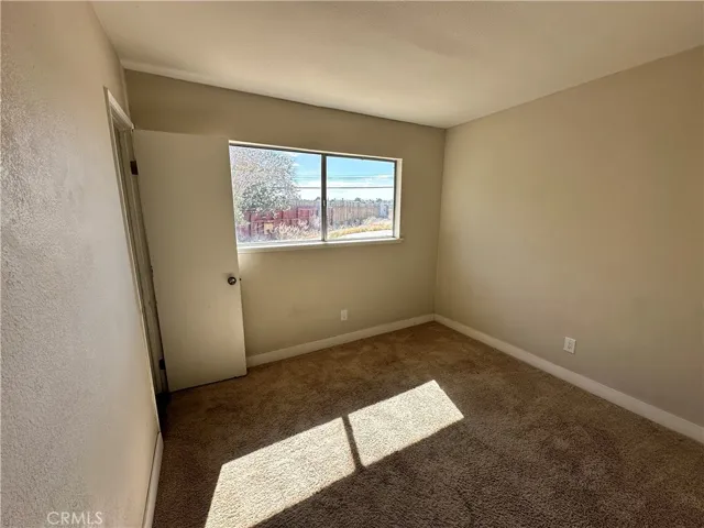 4th Bedroom – Spacious secondary bedroom with a generous closet, plush carpeting, and a versatile layout suitable for guests, a home office, or everyday living.