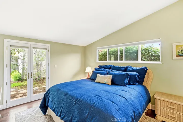 Primary bedroom with vaulted ceiling.