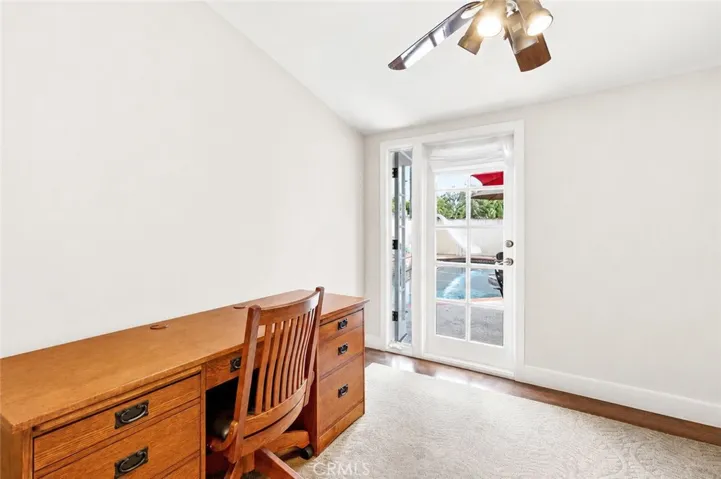 Bedroom #3 with door to courtyard and pool/spa.  Currently set up as home office.  Vaulted ceilings once again.