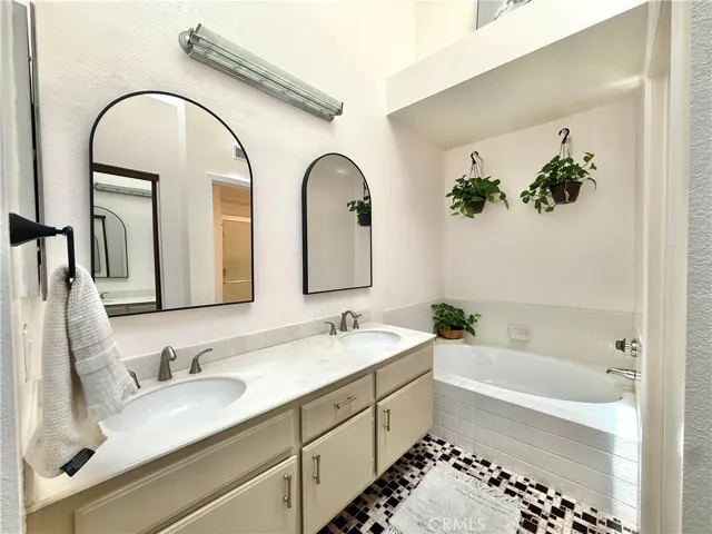Primary bathroom with separate tub and shower.