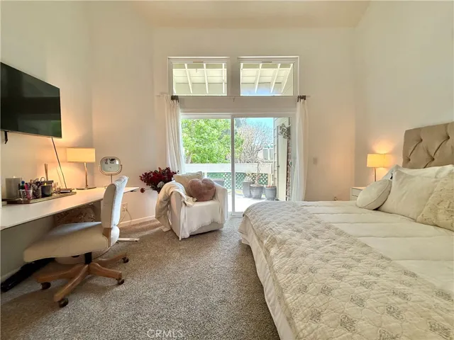 Primary bedroom and access to the outdoor patio.