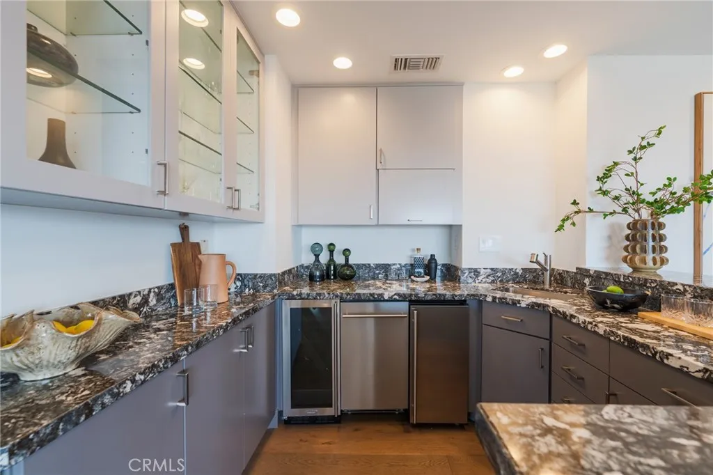 family room bar with DW, ice maker, sink and wine fridge