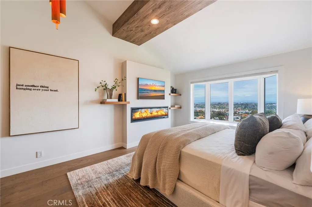 Primary suite with fireplace, vaulted ceilings and views! (fire is computer generated)