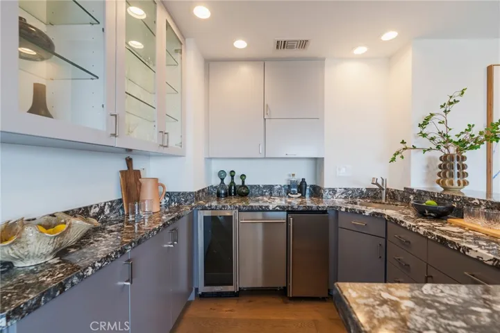 family room bar with DW, ice maker, sink and wine fridge