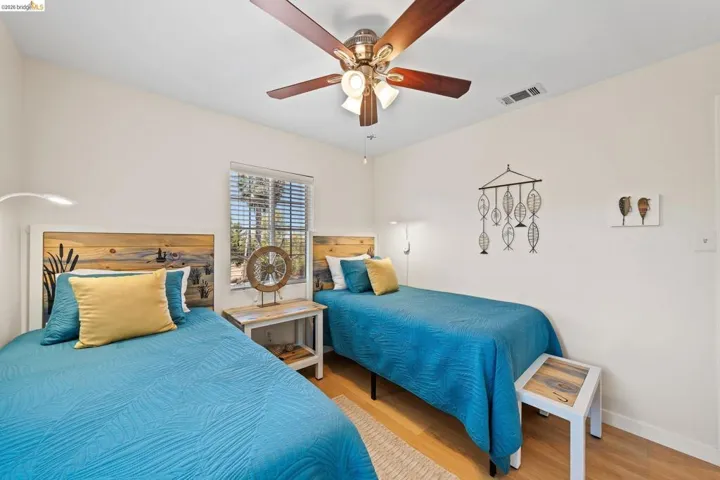 Bright interior room featuring a wood-finish floor and white walls