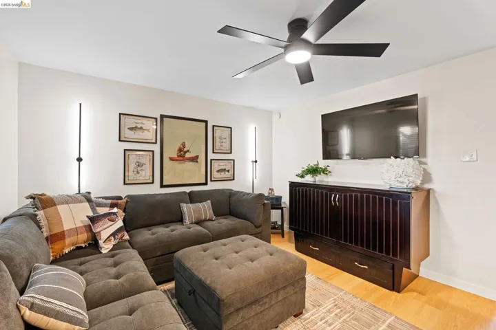 Bright living area featuring light wood-finish flooring
