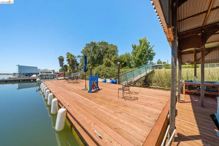 Spacious waterside deck featuring wood planking